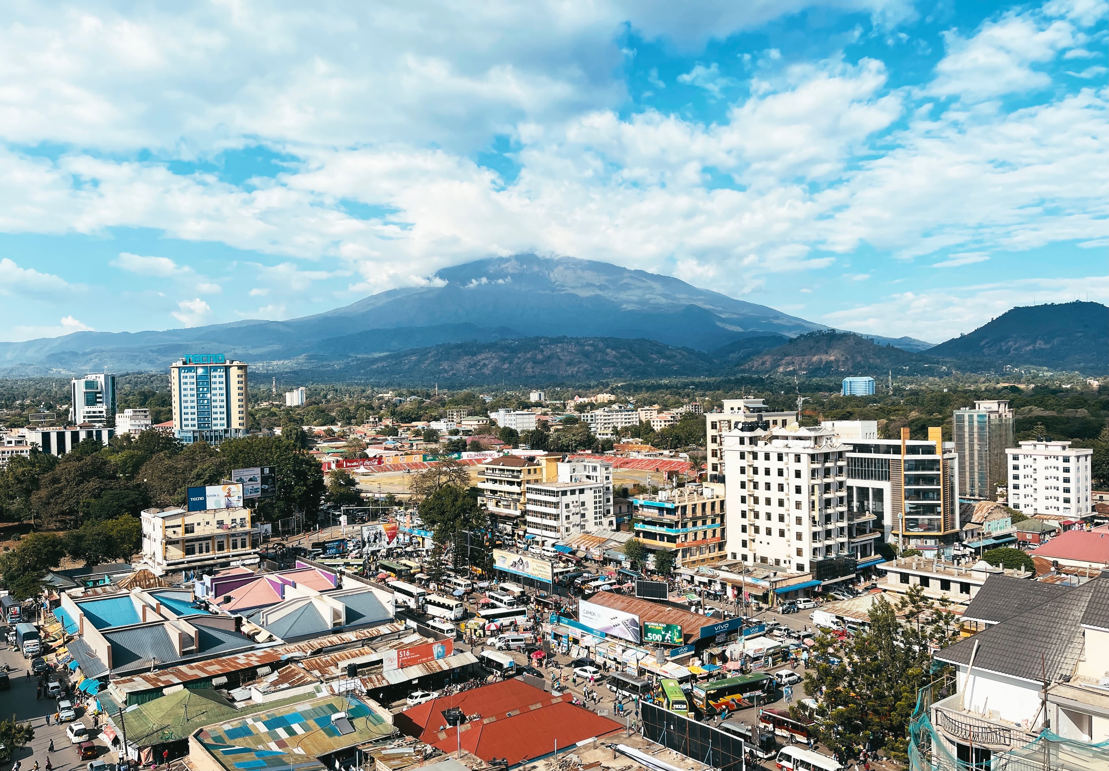 Mount Meru rising behind the buildings and streets of Arusha city, Tanzania